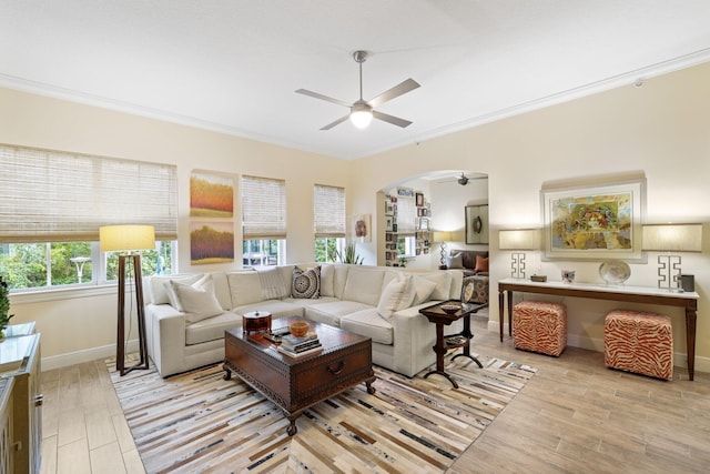 living room with ceiling fan, light hardwood / wood-style flooring, and ornamental molding