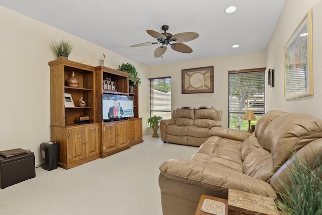 living room with a textured ceiling, recessed lighting, a ceiling fan, and light colored carpet