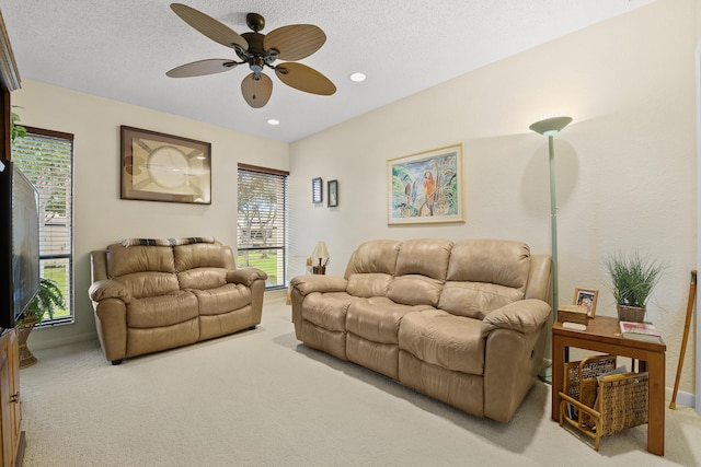 living room with recessed lighting, a ceiling fan, a textured ceiling, and light colored carpet