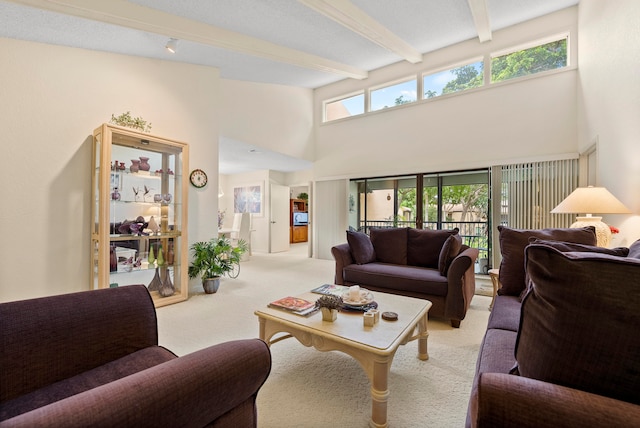 living room featuring beam ceiling, a towering ceiling, and light colored carpet