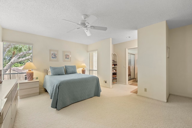 carpeted bedroom featuring ceiling fan and a textured ceiling