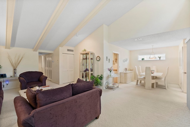 carpeted living room featuring lofted ceiling with beams