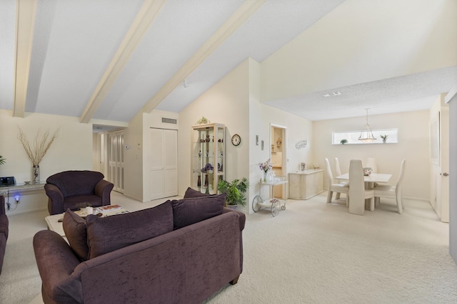 living room with vaulted ceiling with beams, light carpet, and visible vents