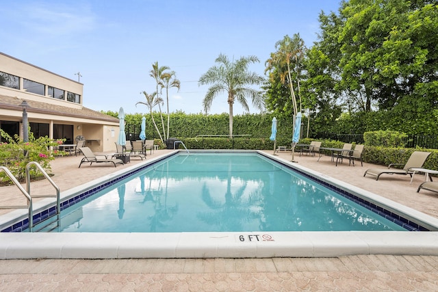 pool featuring a patio and fence