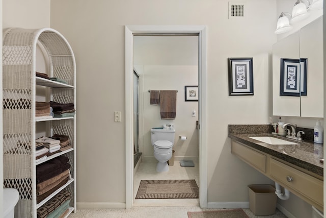 bathroom featuring visible vents, toilet, a shower stall, vanity, and baseboards