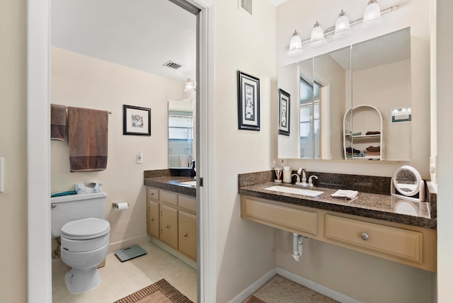 bathroom with tile patterned floors, toilet, and vanity