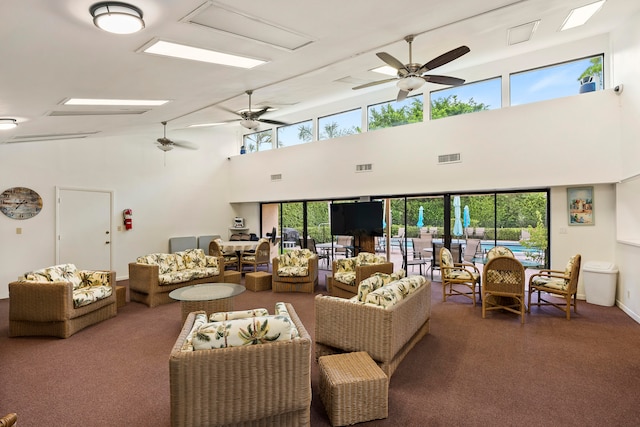 living room featuring ceiling fan, high vaulted ceiling, and carpet flooring