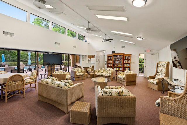 carpeted living room featuring ceiling fan and vaulted ceiling