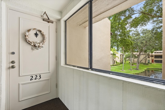 doorway to property featuring a water view