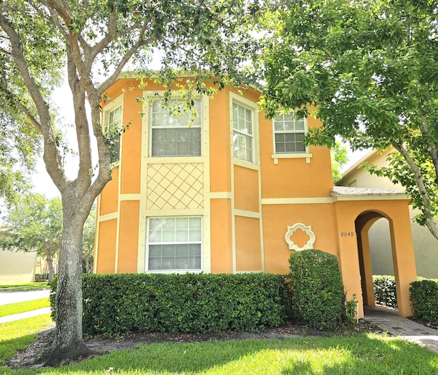 2049 SE June Park Dr, Port Saint Lucie, FL 34952 - view of front facade with stucco siding and a front yard