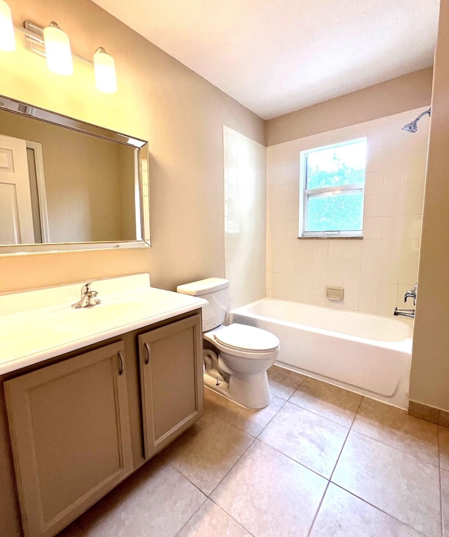 full bathroom with tiled shower / bath, toilet, tile patterned flooring, and vanity