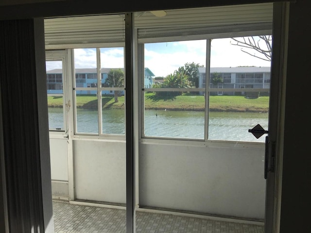 interior space featuring a wealth of natural light and a water view