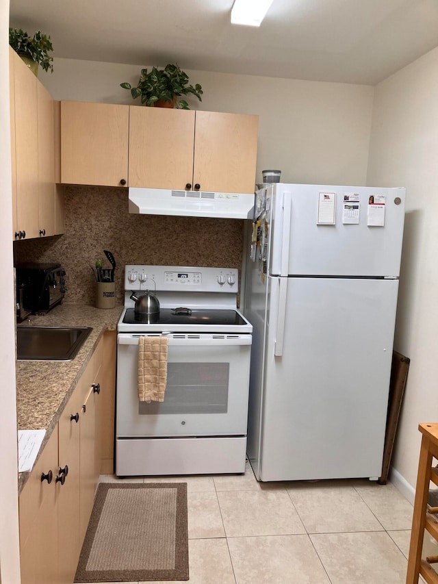 kitchen featuring under cabinet range hood, white appliances, a sink, light countertops, and backsplash