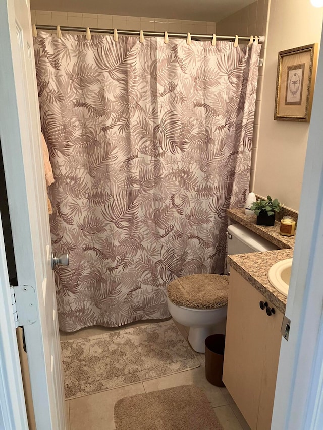 full bathroom featuring toilet, curtained shower, vanity, and tile patterned floors