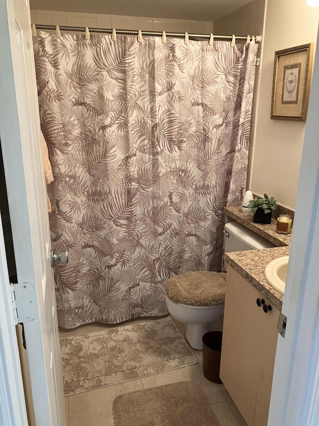 bathroom with tile patterned flooring, a shower with shower curtain, toilet, and vanity