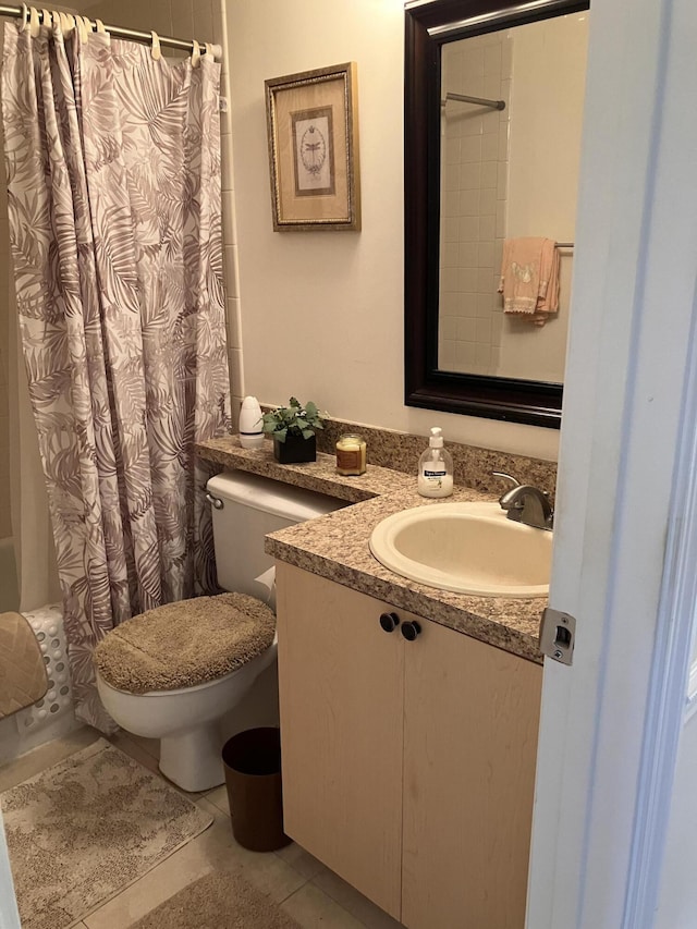 full bath featuring vanity, tile patterned floors, toilet, and shower / tub combo