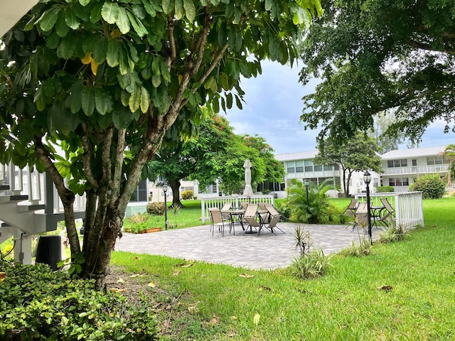 view of property's community featuring a patio area and a yard