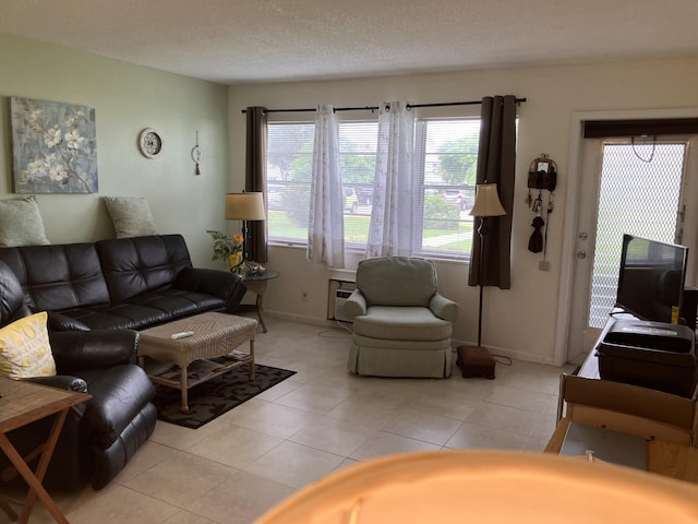 living room featuring baseboards and light tile patterned floors