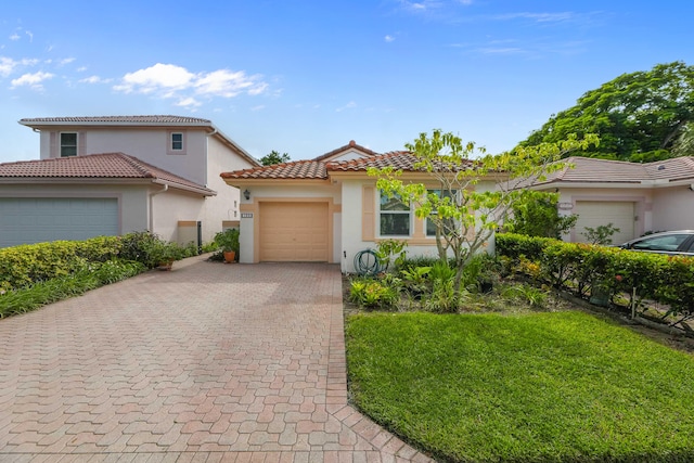 mediterranean / spanish-style house with a front lawn and a garage