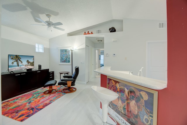 home office featuring vaulted ceiling, a textured ceiling, ceiling fan, and carpet