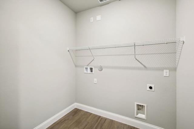 laundry room featuring gas dryer hookup, washer hookup, electric dryer hookup, and dark hardwood / wood-style flooring