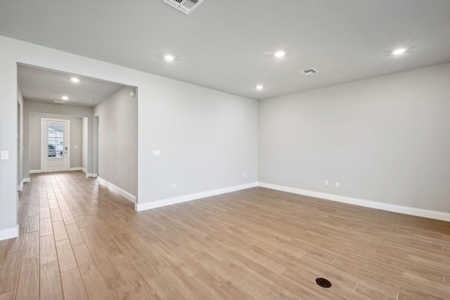 unfurnished room featuring light hardwood / wood-style floors