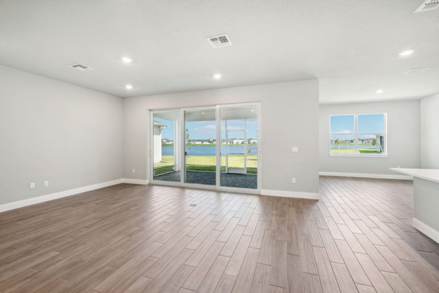 empty room featuring light hardwood / wood-style floors and a healthy amount of sunlight