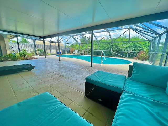 view of swimming pool featuring a lanai and a patio