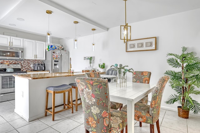 dining space featuring light tile patterned floors