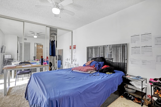 carpeted bedroom featuring a textured ceiling, a closet, and a ceiling fan