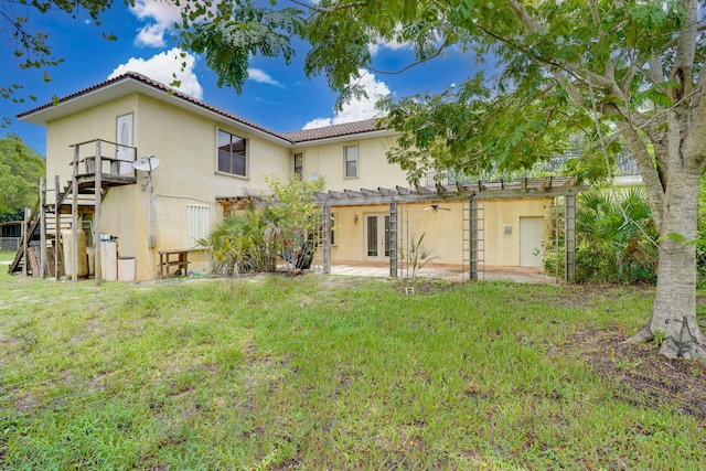 back of property featuring a patio and a lawn