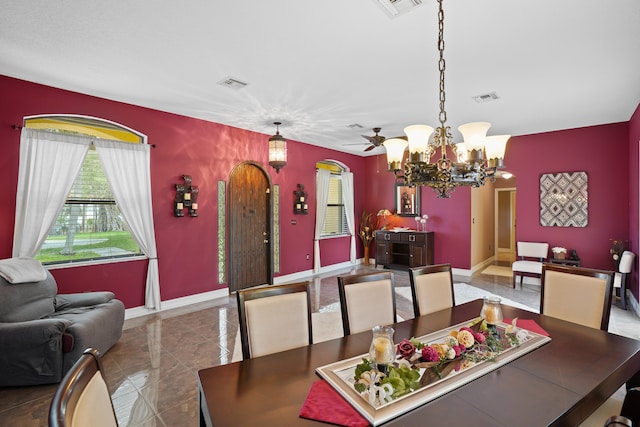 dining area with a chandelier and tile patterned floors