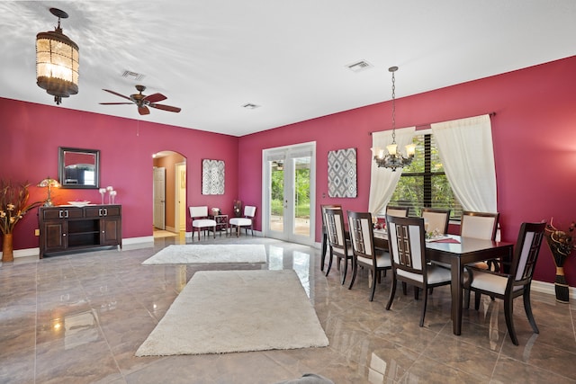 dining space with tile patterned flooring and ceiling fan with notable chandelier