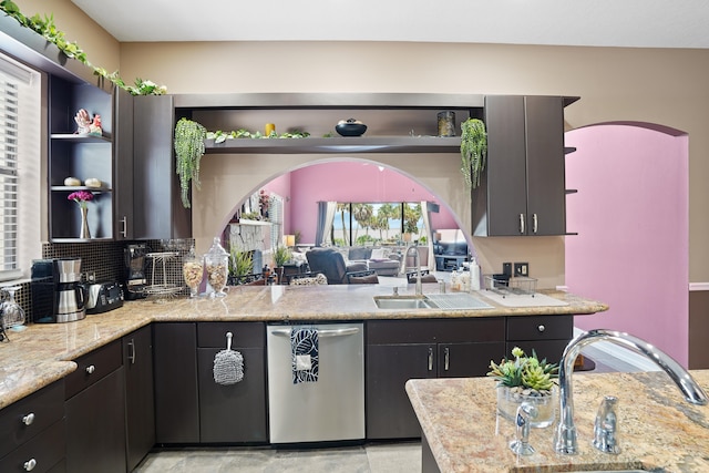 kitchen with sink, kitchen peninsula, decorative backsplash, and dishwasher