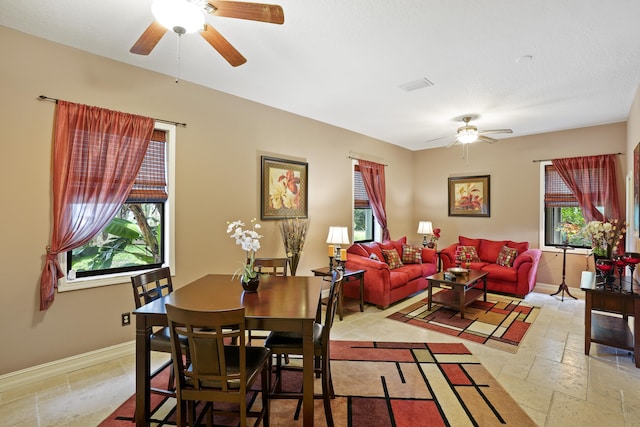 dining area with a wealth of natural light, ceiling fan, and light tile patterned floors