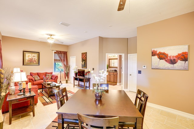 tiled dining room with ceiling fan