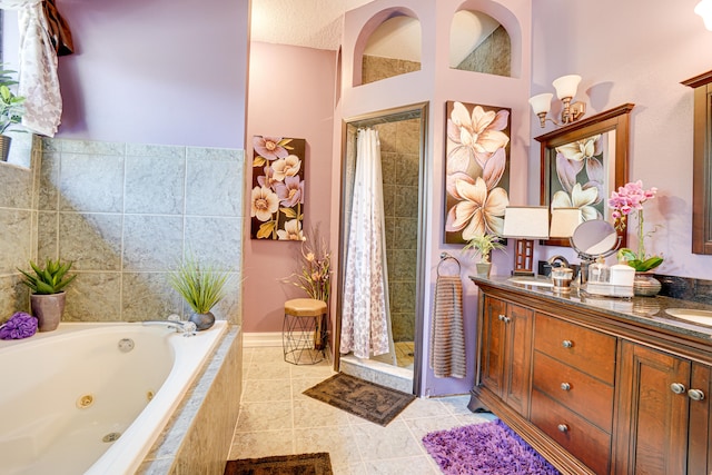 bathroom with dual vanity, plus walk in shower, and tile patterned floors