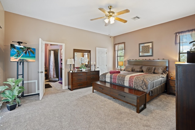 carpeted bedroom with ceiling fan and multiple windows