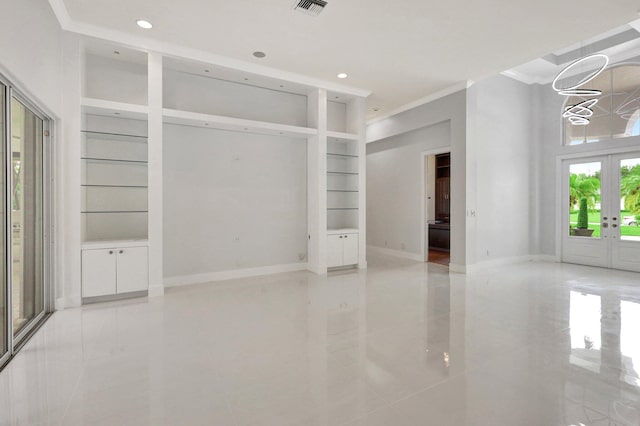 unfurnished living room featuring french doors, crown molding, built in shelves, light tile patterned floors, and a notable chandelier