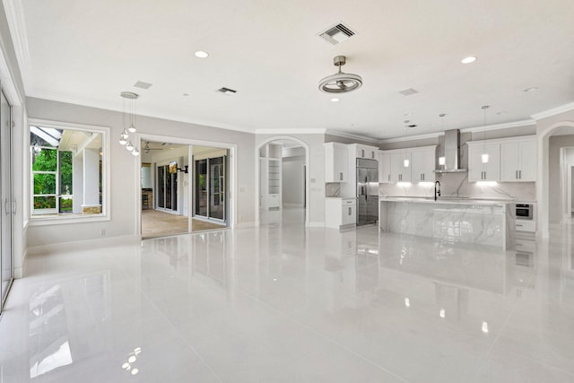 living room featuring light tile patterned floors and crown molding