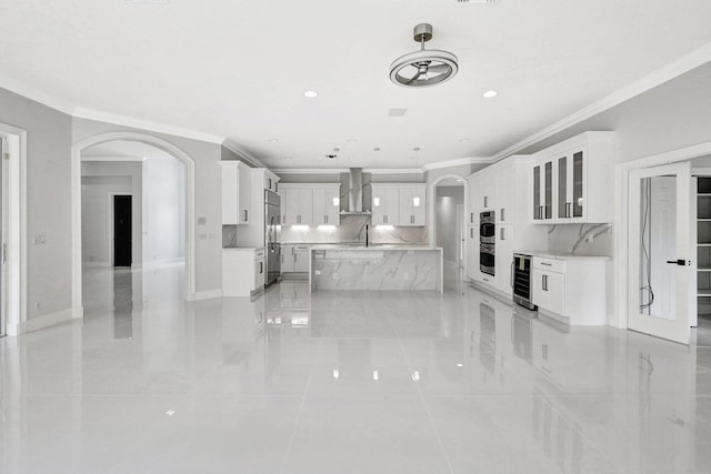 tiled living room featuring sink, beverage cooler, and ornamental molding