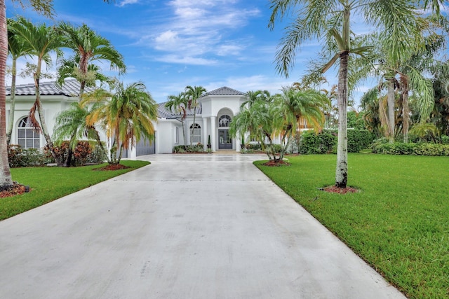 mediterranean / spanish home with a front lawn