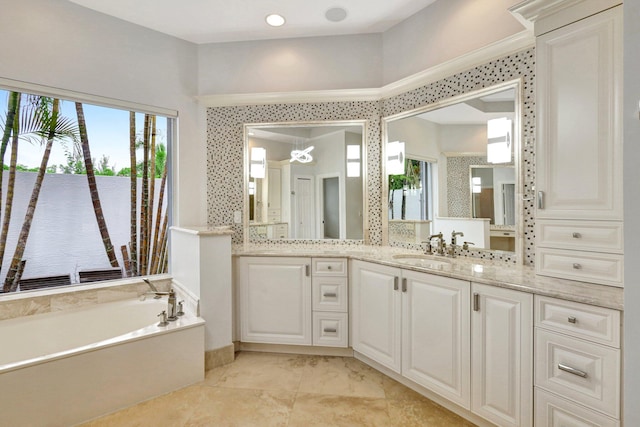 bathroom featuring a water view, plenty of natural light, vanity, and a washtub