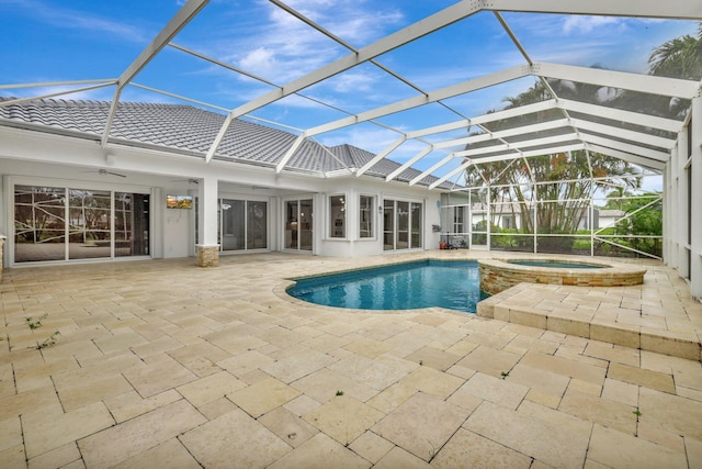 view of pool with ceiling fan, a lanai, an in ground hot tub, and a patio