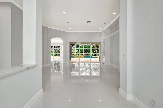 hall featuring crown molding and light tile patterned floors