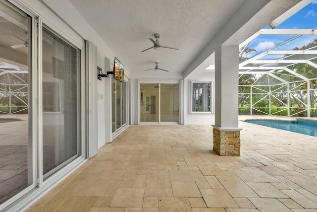 view of patio featuring a lanai and ceiling fan