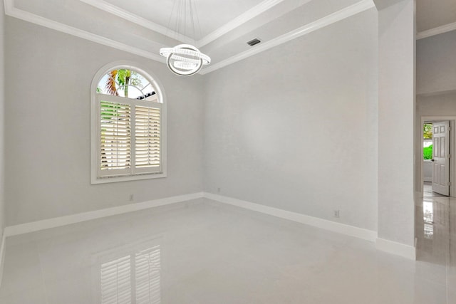 unfurnished room with a tray ceiling, crown molding, and a chandelier