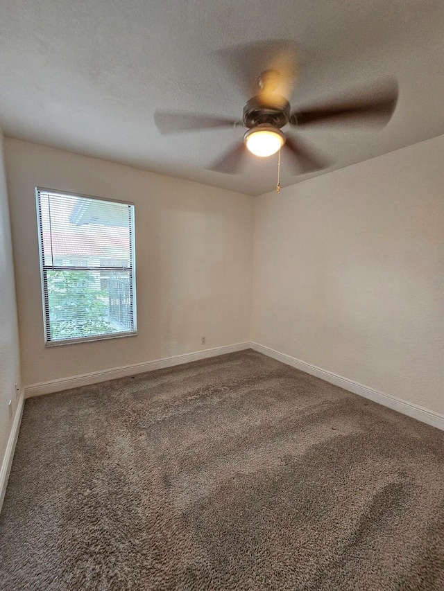 empty room featuring carpet flooring and ceiling fan