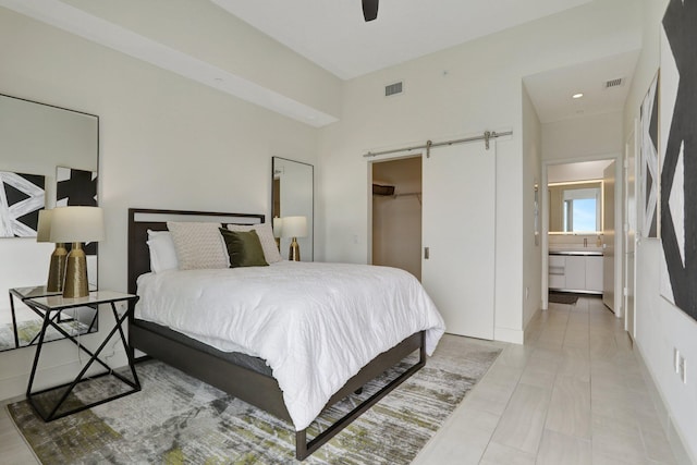 2000 Metropica Way Unit 2607, Sunrise, FL 33323 - bedroom featuring a spacious closet, ensuite bathroom, a barn door, and visible vents