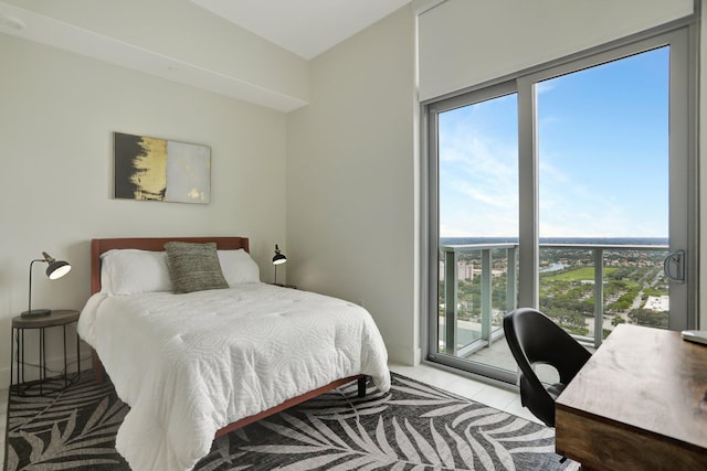 bedroom featuring access to exterior and light tile patterned floors